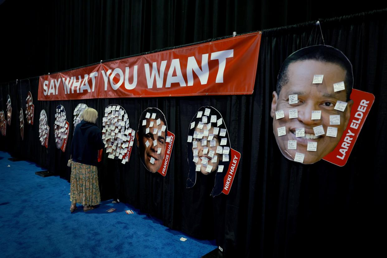 Post-It notes are attached to the faces of GOP candidates for the 2024 presidential nomination at the Turning Point Action Conference in Florida on 15 July. (Getty Images)