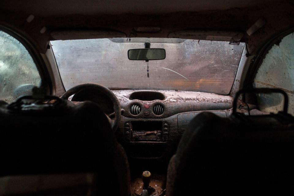 <p>The interior of a car is covered with mud, in Mandra, northwest of Athens, on Nov. 15, 2017, after heavy overnight rainfall.<br> (Photo: Angelos Tzortzinis/AFP/Getty Images) </p>