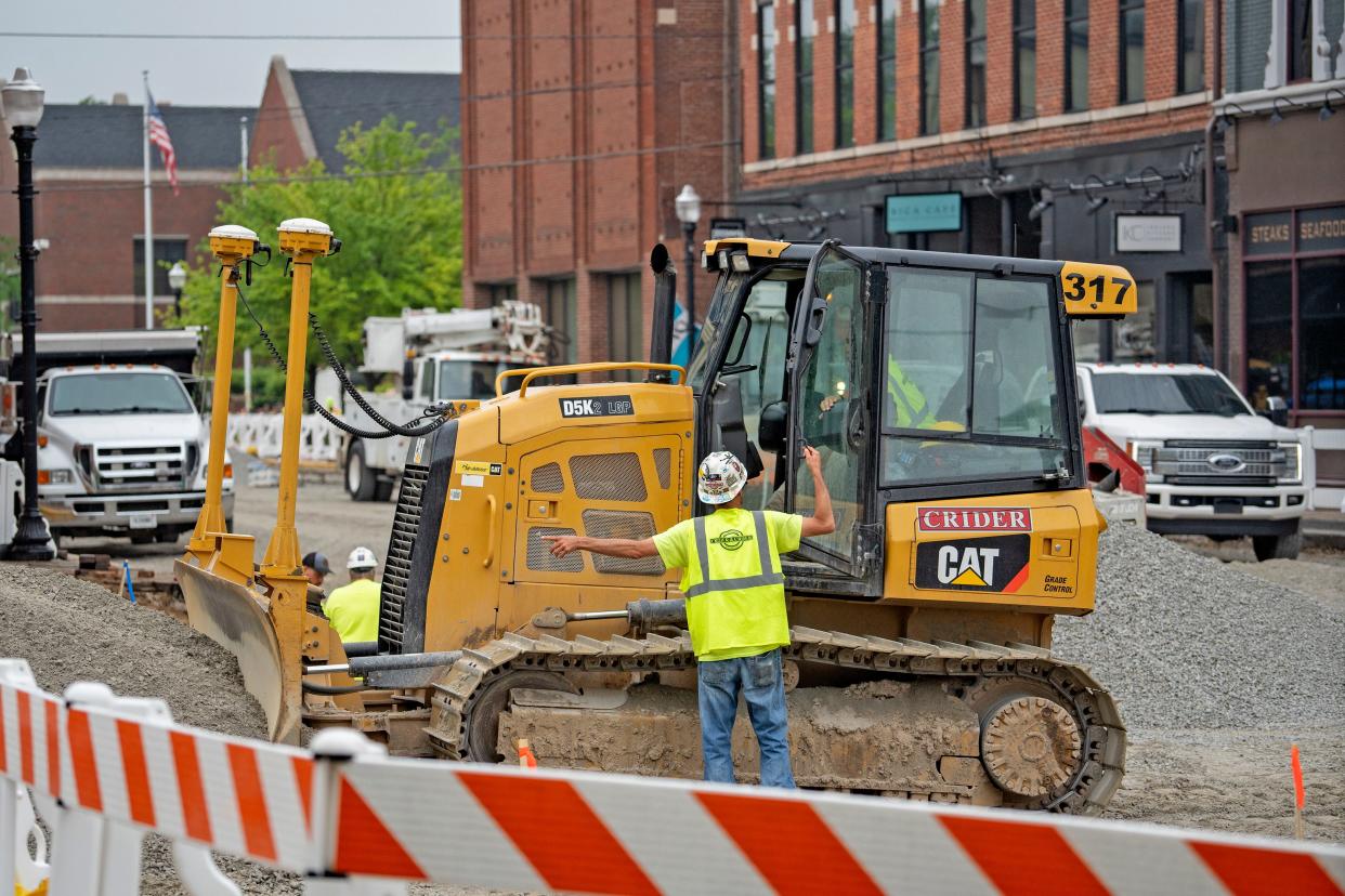 Construction workers work on Conner Street, Thursday, May 9, 2024 in Noblesville.