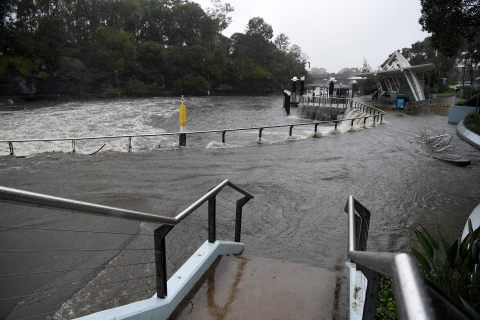 Water overflows the banks of the Parramatta River after heavy rains in Sydney, Friday, February 7, 2020.