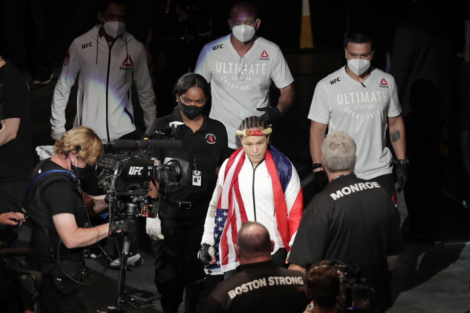 Michelle Waterson, center, enters the arena before her fight against Carla Esparaza at a UFC 249 mixed martial arts event, Saturday, May 9, 2020, in Jacksonville, Fla. (AP Photo/John Raoux)