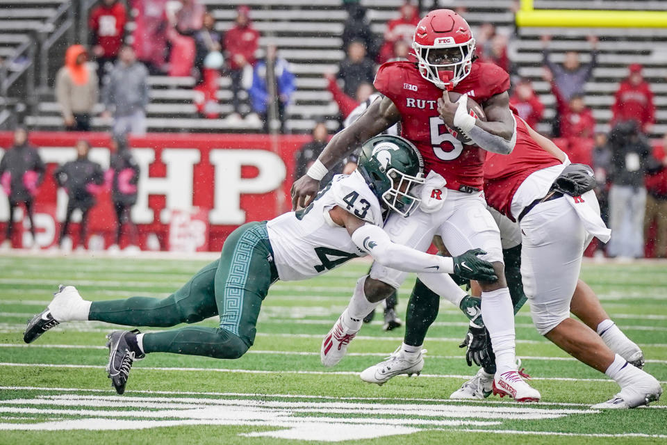 Rutgers running back Kyle Monangai (5) is tackled by Michigan State defensive back Malik Spencer (43) during the second half of an NCAA college football game Saturday on Oct. 14, 2023, in Piscataway, N.J. (AP Photo/Bryan Woolston)