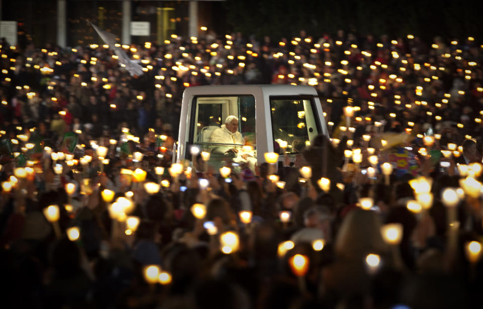 FILE - Pope Benedict XVI rides in the popemobile as he leaves Fatima's Sanctuary in in Fatima, Portugal, on May 12, 2010. Pope Emeritus Benedict XVI, the German theologian who will be remembered as the first pope in 600 years to resign, has died, the Vatican announced Saturday. He was 95. (AP Photo/Emilio Morenatti, File)