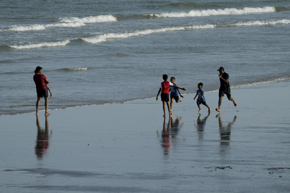 A group plays on the beach ahead of Beryl's arrival, Saturday, July 6, 2024, in Port Aransas, Texas. (AP Photo/Eric Gay)