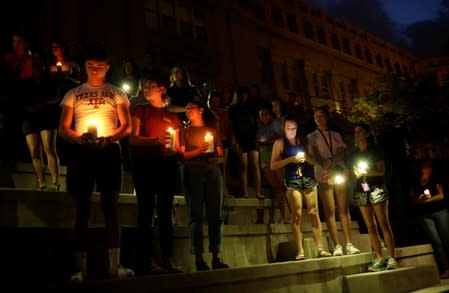 Mourners taking part in a vigil at El Paso High School after a mass shooting at a Walmart store in El Paso
