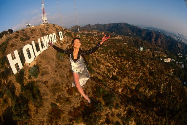 Actress Michelle Yeoh in mid-air over the famous Hollywood sign in November 1998 in Los Angeles, California.