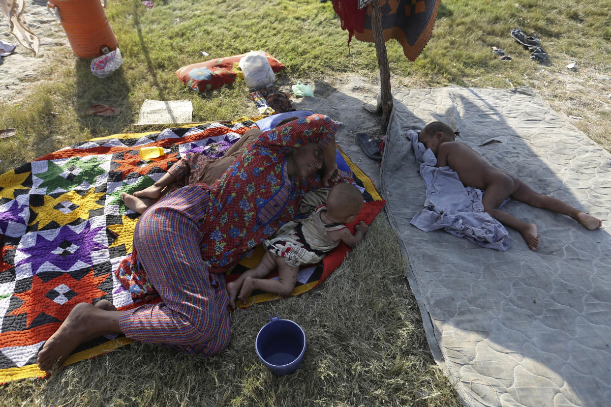 A woman sleeps on the ground as she takes refuge from her flood-hit home, in Larkana District, of Sindh, Pakistan, Thursday, Sept. 8, 2022. (AP Photo/Fareed Khan)