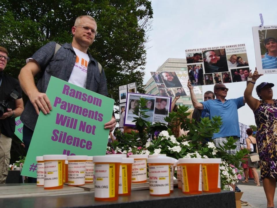 Ryan Hampton protests in front of Purdue Pharma headquarters in Stamford, Connecticut in August 2018.