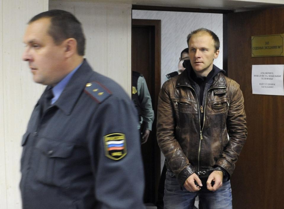 Photographer Denis Sinyakov, one of the 30 people detained after a Greenpeace protest at the Prirazlomnaya platform, enters a hall of a district court in Murmansk