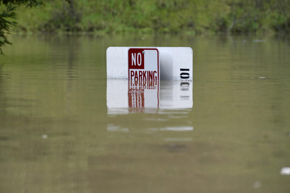 A No Parking sign is almost completely submerged in flood waters from the Russian River in Forestville, Calif., on Feb. 27, 2019. (Photo: Michael Short/AP)