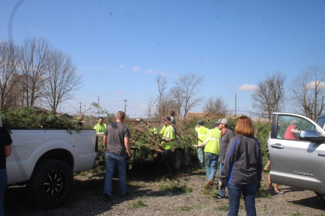 Residents line up at the Morgan County Fairgrounds on April 3, 2023, to dump fallen trees. The "pit" area behind the track at the fairgrounds was used to collect debris from a tornado in March.