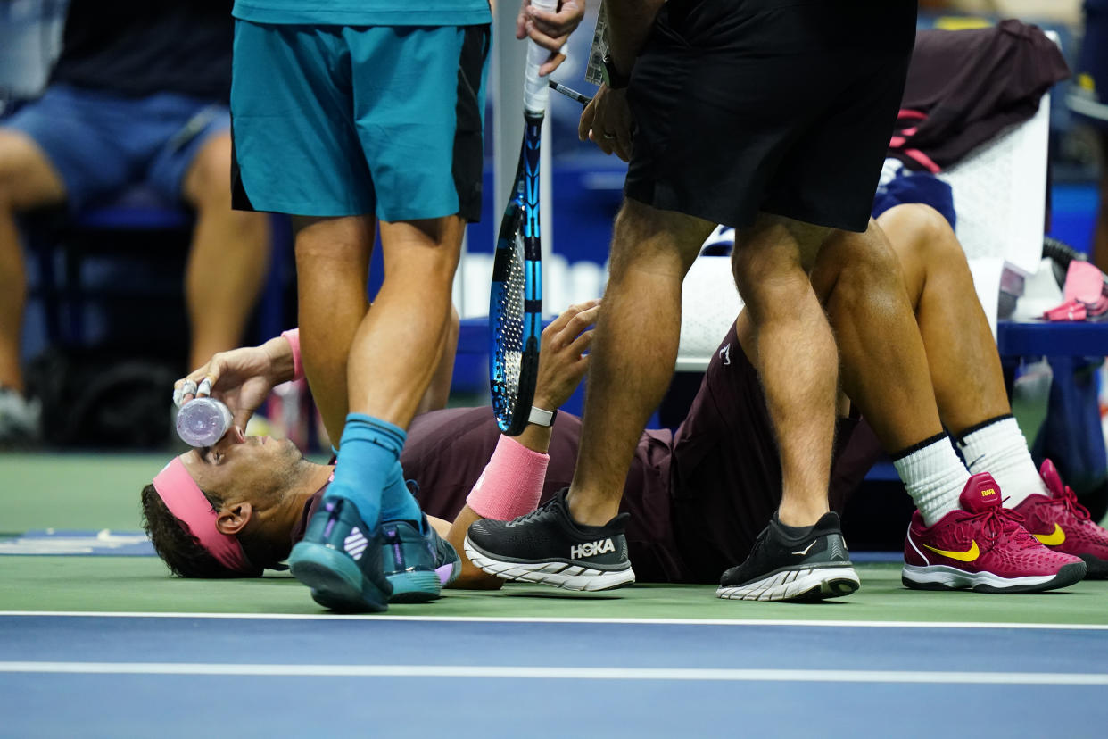 Rafael Nadal, of Spain, holds a bottle to his face during a medical timeout during a match against Fabio Fognini, of Italy, during the second round of the U.S. Open tennis championships, early Friday, Sept. 2, 2022, in New York. (AP Photo/Frank Franklin II)