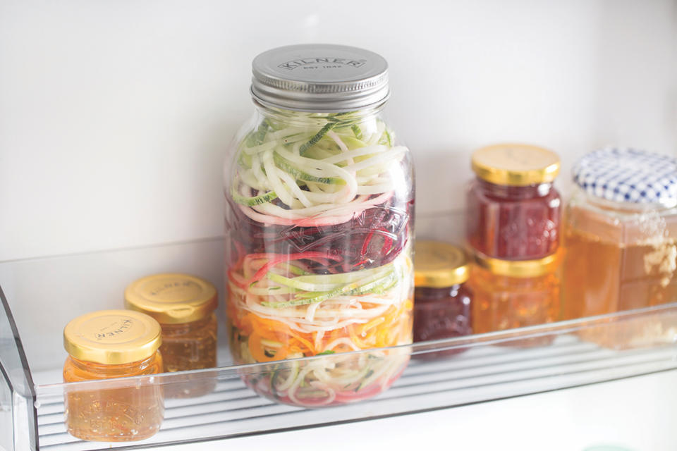 jars of jam in a fridge door
