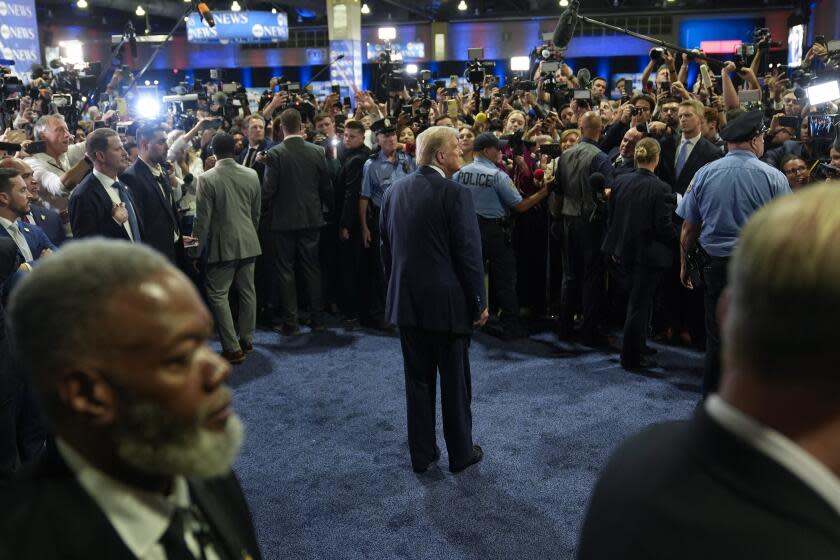 Republican presidential nominee former President Donald Trump, center, speaks to reporters in the spin room after a presidential debate with Democratic presidential nominee Vice President Kamala Harris, Tuesday, Sept. 10, 2024, in Philadelphia. (AP Photo/Pablo Martinez Monsivais)