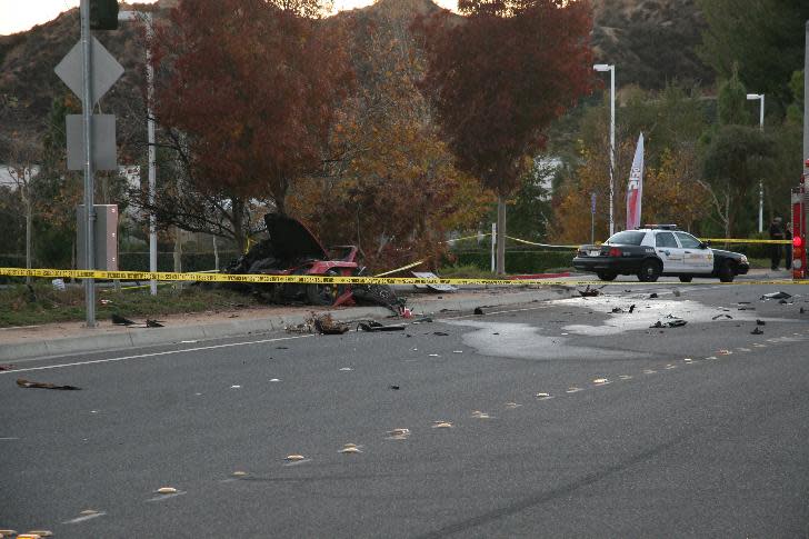 This Nov. 30, 2013 photo released by the Los Angeles County Sheriff Department on Tuesday, March 25, 2014, shows the wreckage of a Porsche that crashed into a light pole in Valencia, Calif. Crash investigators have determined that the car carrying "Fast & Furious" star Paul Walker was traveling up to 90 mph (151 kph) when it went out of control on a city street and smashed into a light pole, killing the actor and his friend Roger Rodas. A person who has reviewed the investigators’ report told The Associated Press that it concluded unsafe driving, not mechanical problems, caused the crash. The person requested anonymity because the report has not been officially released yet. (AP Photo/Los Angeles County Sheriff)