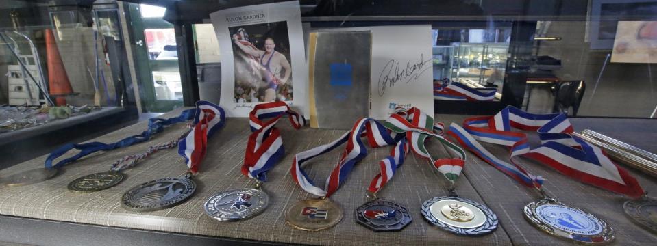 FILE - In this Oct. 25, 2014, file photo, Rulon Gardner's medals are shown at an auctioneer's warehouse in Salt Lake City, Utah. An Olympic Channel documentary debuting Wednesday, July 22, 2020, chronicles the highs and lows of Rulon Gardner in the 20 years since his stunning gold-medal victory in the 2000 Olympics. (AP Photo/Rick Bowmer, File)
