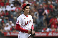 Los Angeles Angels pitcher Shohei Ohtani smiles after finishing the seventh inning of a baseball game against the Seattle Mariners, Sunday, Sept. 26, 2021, in Anaheim, Calif. The Mariners won 5-1. (AP Photo/Michael Owen Baker)