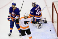 Philadelphia Flyers left wing James van Riemsdyk (25) celebrates a goal by teammate right wing Tyler Pitlick (not shown) as New York Islanders defenseman Adam Pelech (3) and goaltender Semyon Varlamov (40) react during first-period NHL Stanley Cup Eastern Conference playoff hockey game action in Toronto, Saturday, Aug. 29, 2020. (Frank Gunn/The Canadian Press via AP)