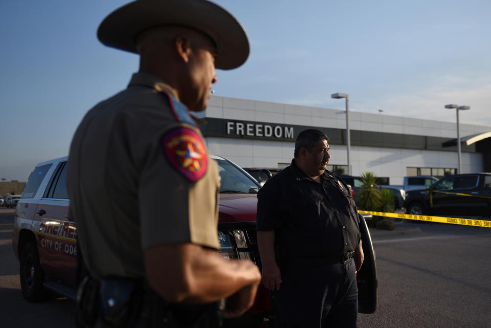 A Texas state trooper and other emergency personnel monitor the scene at a local car dealership following a shooting in Odessa, Texas, U.S. September 1, 2019. REUTERS/Callaghan O'Hare