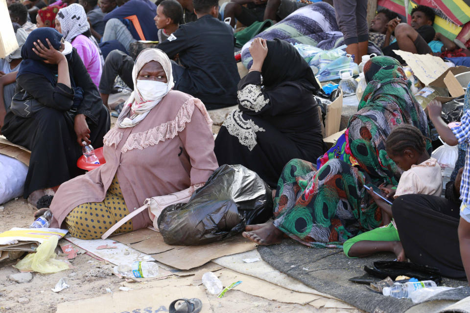 FILE - In this Oct. 9, 2021 file photo, dozens of migrants protest in front of the office of the United Nation's humanitarian body in Tripoli, Libya. The United Nations says it has resumed humanitarian evacuation flights for migrants stranded in Libya. The announcement comes after a massive crackdown on migrants inside the country and the suspension of the flights for several months. (AP Photo/Yousef Murad, File)