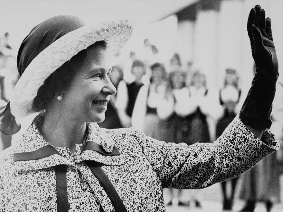 A smiling Queen Elizabeth waves to a happy crowd of onlookers at the Canadian National Exhibition grounds in Toronto on June 26, 1973. While at the CNE, the Queen and Prince Philip were entertained by various dance troupes and choirs. (The Canadian Press - image credit)