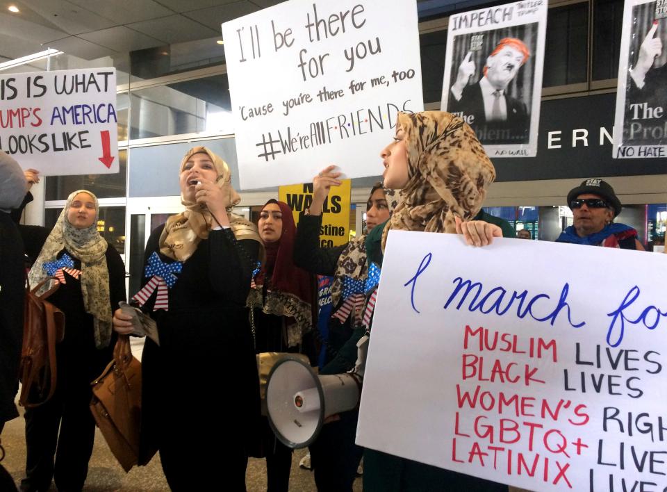 Protesters against President Trump's temporary travel ban on citizens from seven Muslim-majority nations stand in front of the Bradley Terminal at Los Angeles International Airport on Feb. 4, 2017, in Los Angeles after the order was lifted.