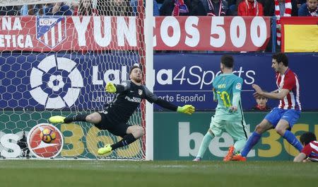 Football Soccer - Atletico Madrid v Barcelona - Spanish La Liga Santander - Vicente Calderon Stadium, Madrid, Spain, 26/02/17 Barcelona's Lionel Messi scores a goal past Atletico Madrid's goalkeeper Jan Oblak. REUTERS/Juan Medina