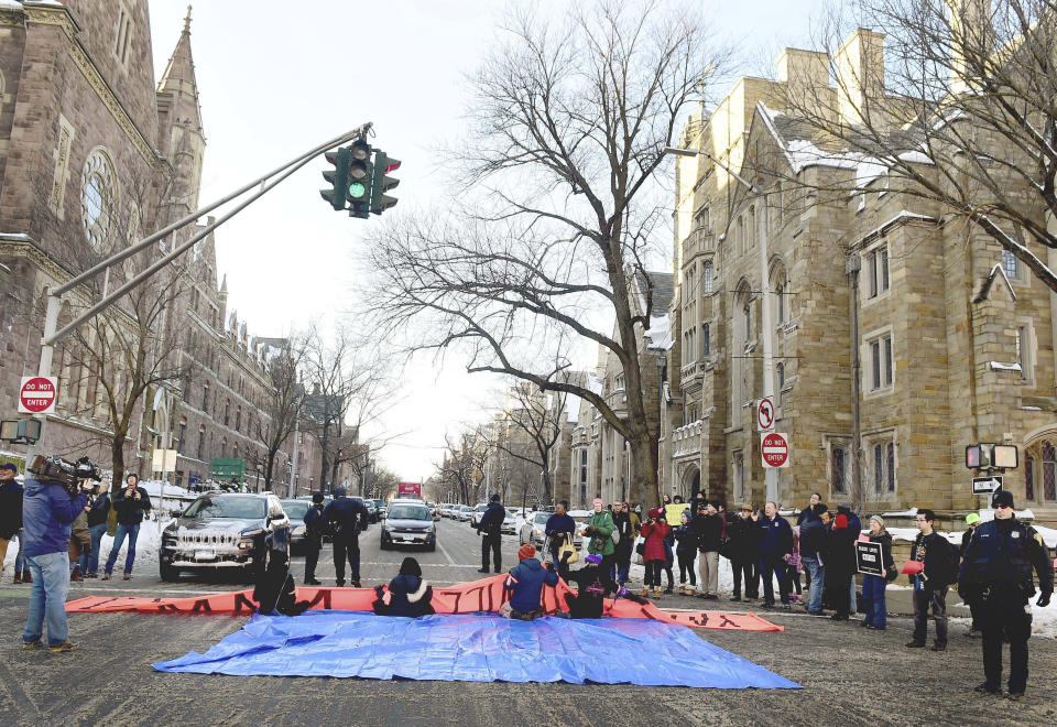 New Haven Police arrested demonstrators who blocked the intersection of Elm and College Streets in New Haven, Conn., Friday, Feb. 10, 2017, and refused to move during a protest and demonstration in favor of changing the name of Yale University's Calhoun College. The peaceful arrests were pre-planned and coordinated between the demonstrators and New Haven Police. (Peter Hvizdak/New Haven Register via AP)