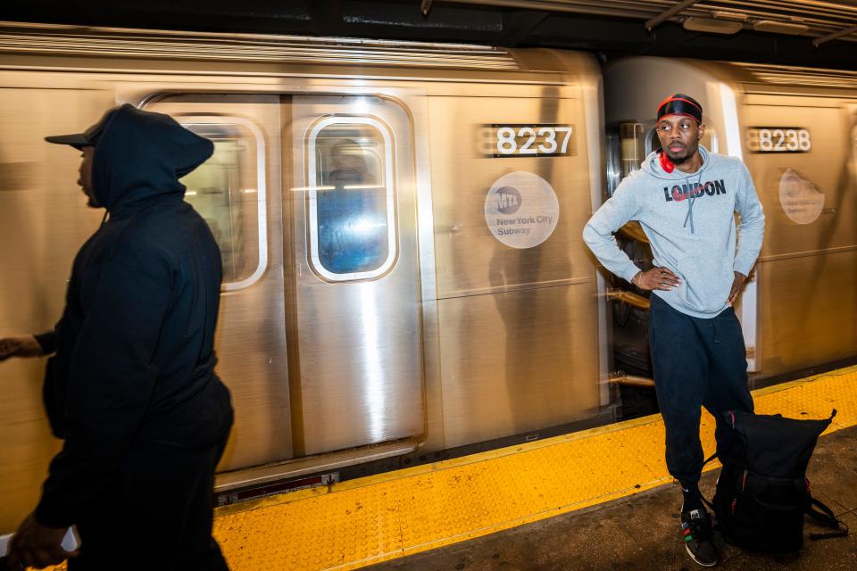 Dancers wait to catch the next subway car.