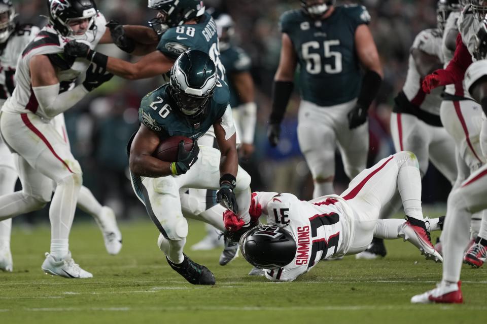 Atlanta Falcons safety Justin Simmons (31) stops Philadelphia Eagles running back Saquon Barkley (26) during the second half of an NFL football game Monday, Sept. 16, 2024, in Philadelphia. (AP Photo/Matt Rourke)