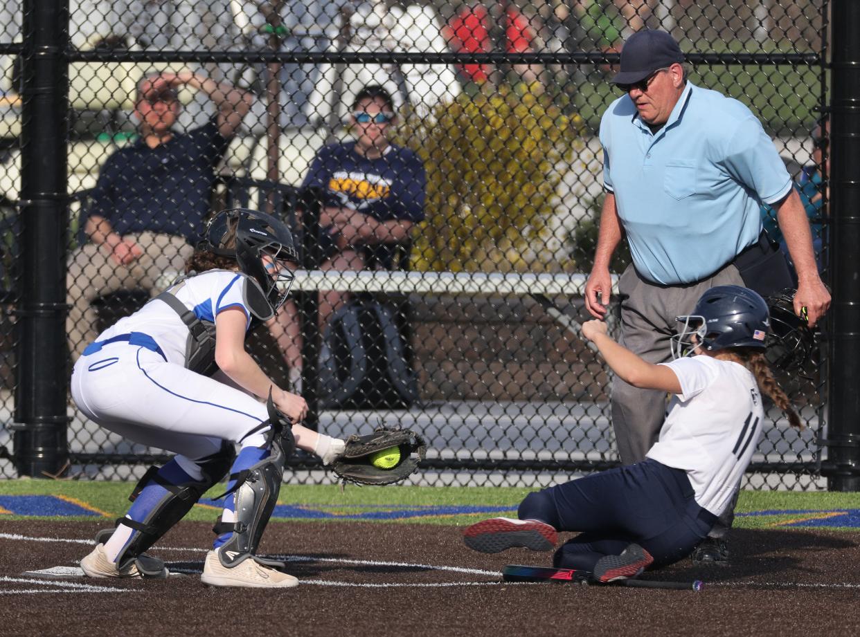 Schroeder catcher Sarah Ferruzza gets the out at home against Thomas.