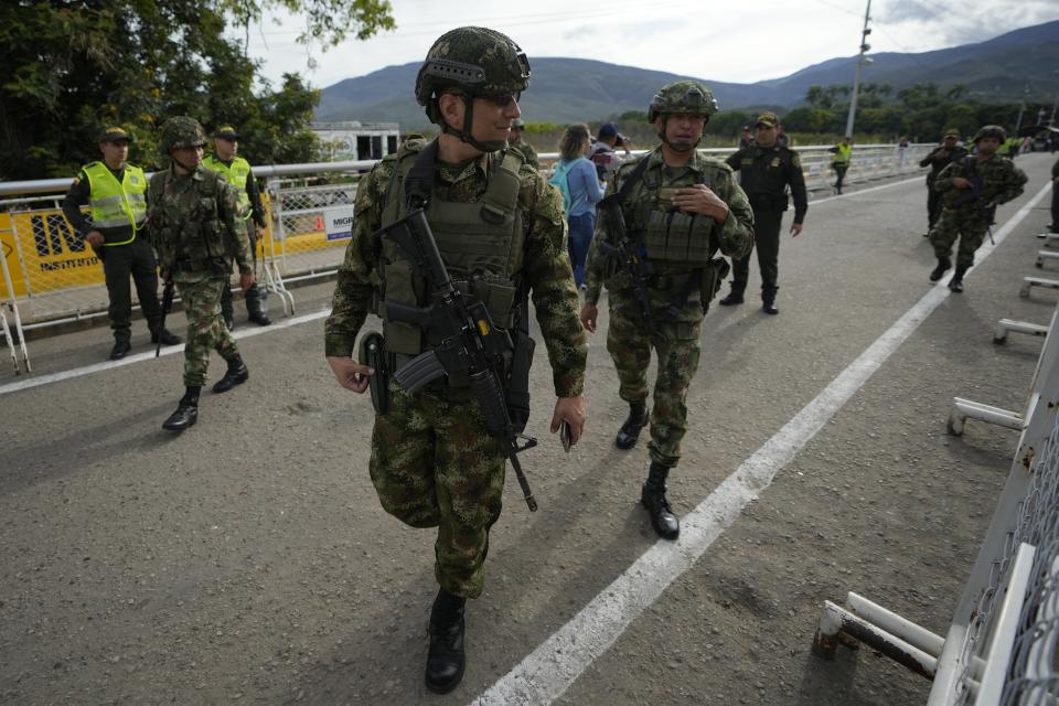 Colombian soldiers patrol the Simon Bolivar International Bridge between Cucuta, Colombia and San Antonio del Tachira, Venezuela, Monday, Sept. 26, 2022. In a ceremonial act to mark the resumption of commercial relations between the two nations, vehicles with merchandise will cross the bridge on Monday for the first time in seven years. (AP Photo/Fernando Vergara)