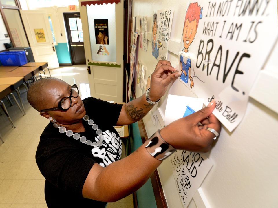 Big changes could be coming to Illinois schools through pending legislation and budget requests from Gov. JB Pritzker. Dubois Elementary teacher Shalanda Gaines puts up poster in the hall outside her classroom Wednesday, Aug. 17, 2022.