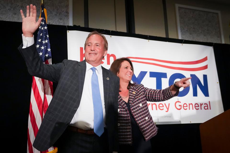 Texas Attorney General Ken Paxton waves to supporters with his wife, state Sen. Angela Paxton, R-McKinney, during a primary election night event on March 1 in McKinney.