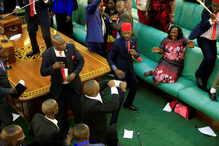 Ugandan opposition lawmakers fight with plain-clothes security personnel in the parliament while protesting a proposed age limit amendment bill debate to change the constitution for the extension of the president's rule, in Kampala, Uganda September 27, 2017. REUTERS/James Akena TPX IMAGES OF THE DAY