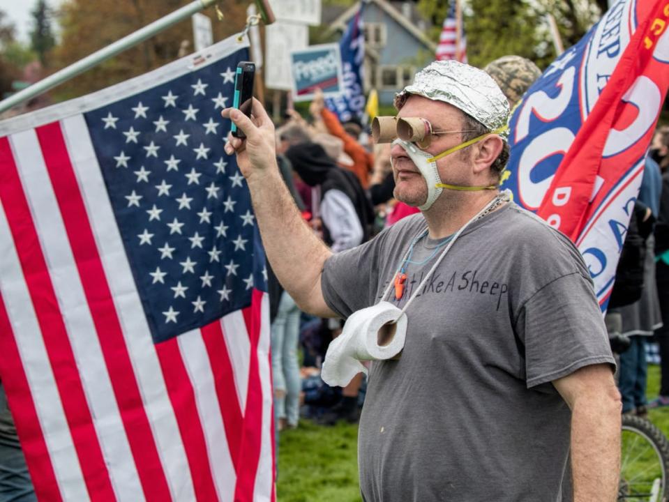 <div class="inline-image__caption"><p>Among the 2,500 protesters gathered for this anti-lockdown rally was a aluminum-foil hatted, faux-masked, toilet-paper-wearing man sporting a "Fight Like a Sheep" t-shirt. (Olympia, Wash., April 19, 2020)</p></div> <div class="inline-image__credit">Jeff Schwilk</div>