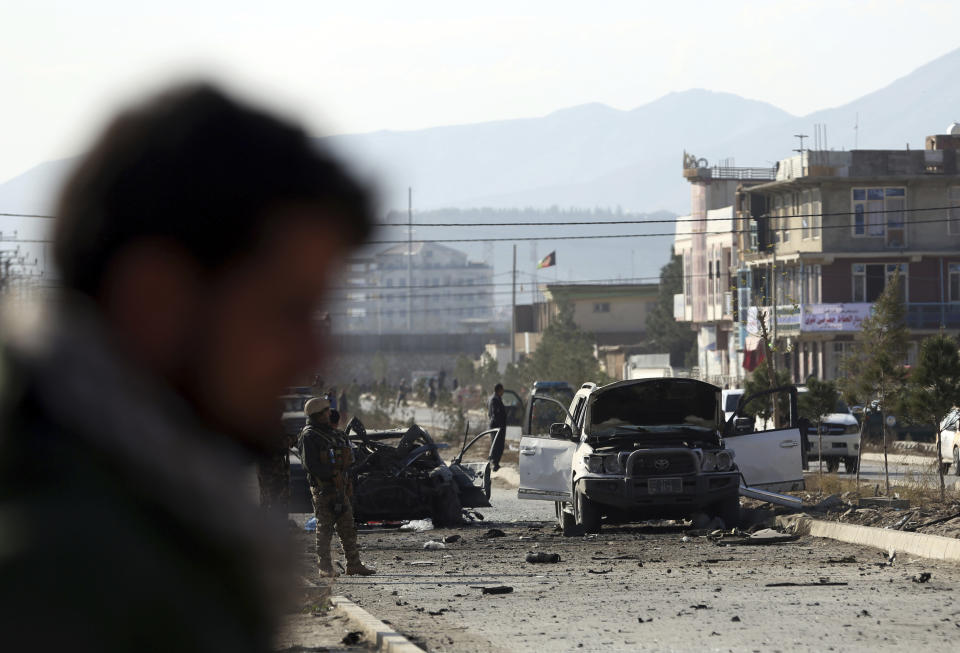 Afghan security personnel gather at the site of car bomb attack in Kabul, Afghanistan, Wednesday, Nov. 13, 2019. A car bomb detonated in the Afghan capital of Kabul during Wednesday's morning commute, killing several people, officials said. (AP Photo/Rahmat Gul)