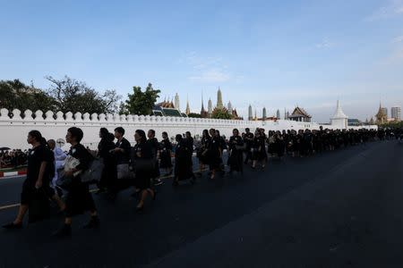 Mourners walk in line as they attend the Royal Cremation ceremony of Thailand's late King Bhumibol Adulyadej near the Grand Palace in Bangkok, Thailand, October 25, 2017. REUTERS/Kerek Wongsa