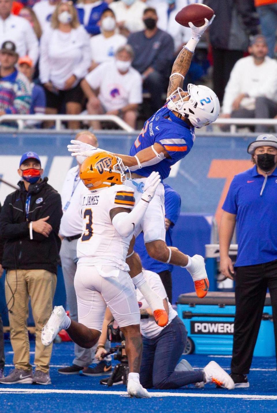 Boise State wide receiver Khalil Shakir reaches high for a one-handed catch while defended by UTEP safety Ty’reke James during the first half of their game at Albertsons Stadium.