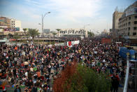 Followers of Shiite cleric Muqtada al-Sadr,gather in Tahrir Square, Baghdad, Iraq, Friday, Nov. 27, 2020. Thousands took to the streets in Baghdad on Friday in a show of support for a radical Iraqi cleric ahead of elections slated for next year, stirring fears of a spike in coronavirus cases. (AP Photo/Khalid Mohammed)