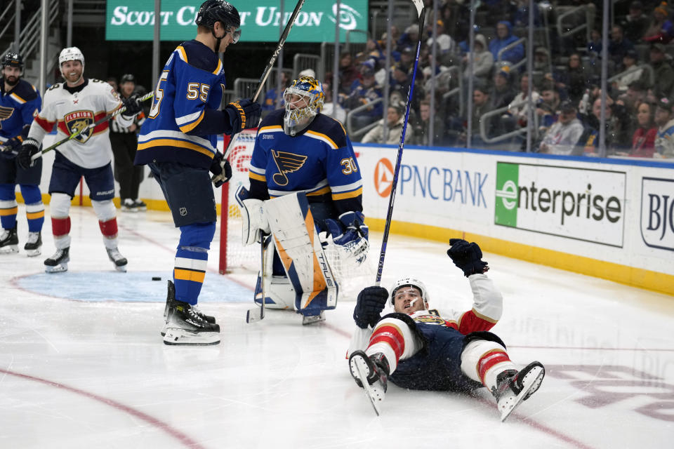 Florida Panthers' Matthew Tkachuk, right, celebrates after scoring past St. Louis Blues goaltender Joel Hofer (30) and Colton Parayko (55) during the third period of an NHL hockey game Tuesday, Jan. 9, 2024, in St. Louis. (AP Photo/Jeff Roberson)