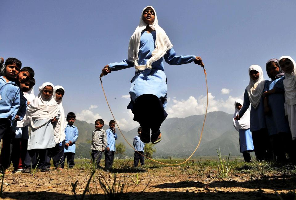 Kashmiri school girls playing during recess in Kulhama district, Bandipora on August 11, 2015 in Srinagar, India. 