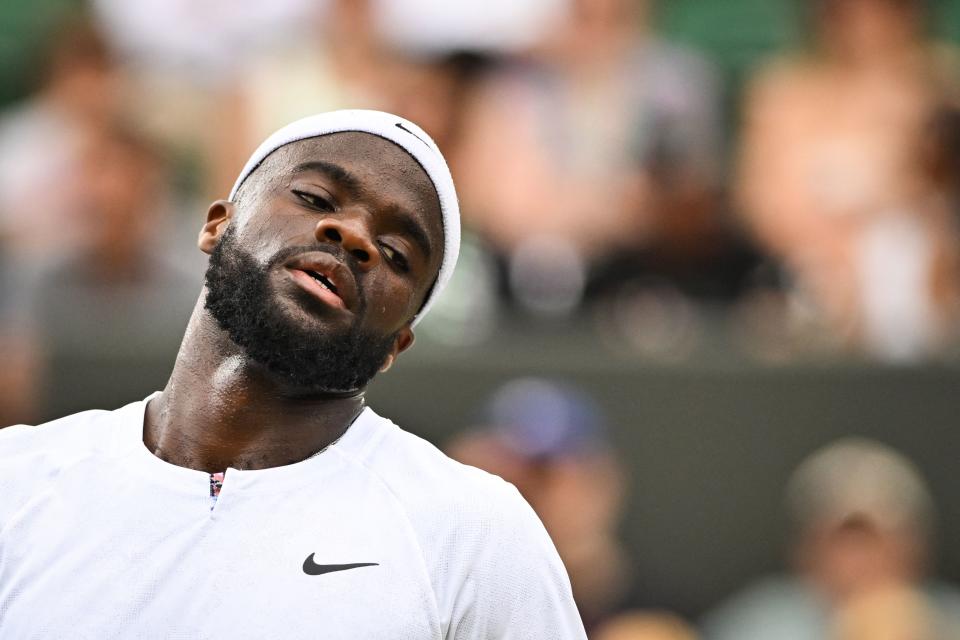 US player Frances Tiafoe reacts as he plays against Belgium's David Goffin during their round of 16 men's singles tennis match on the seventh day of the 2022 Wimbledon Championships at The All England Tennis Club in Wimbledon, southwest London, on July 3, 2022. - RESTRICTED TO EDITORIAL USE (Photo by Glyn KIRK / AFP) / RESTRICTED TO EDITORIAL USE (Photo by GLYN KIRK/AFP via Getty Images)
