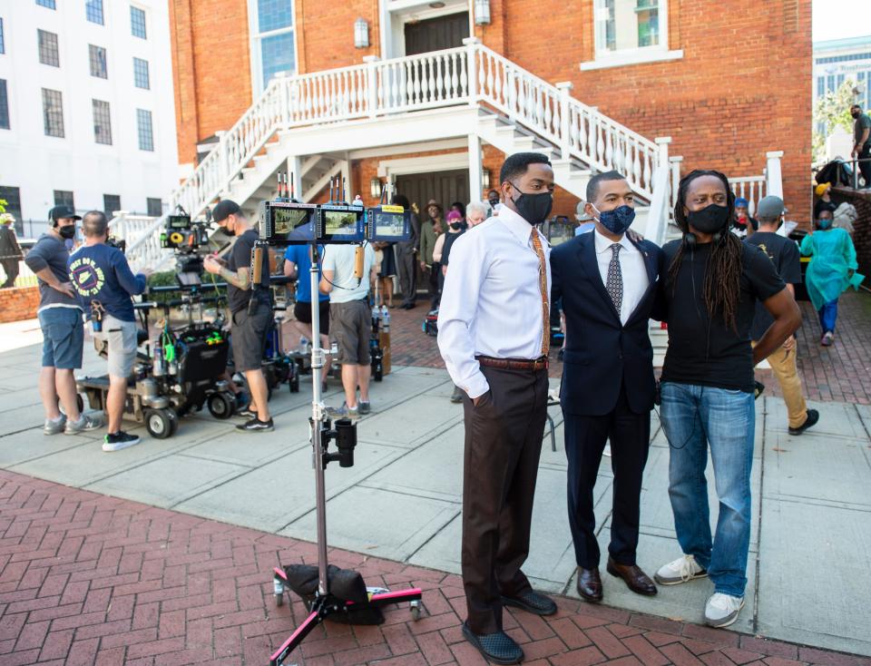 Mayor Steven Reed poses for a photo with actor Dulé Hill and creator Saladin Patterson during filming for The Wonder Years outside Dexter Avenue King Memorial Baptist Church in Montgomery on Oct. 13, 2021.