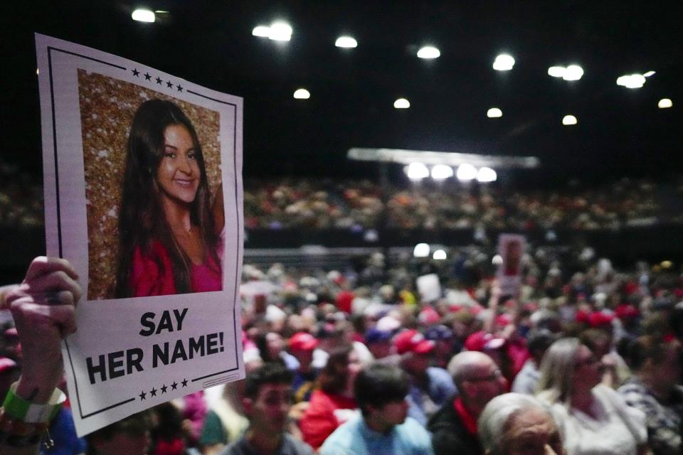 FILE - A supporter holds a sign with a photo of Laken Riley before Republican presidential candidate former President Donald Trump speaks at a campaign rally Saturday, March 9, 2024, in Rome Ga. A man accused of killing a nursing student whose body was found on the University of Georgia campus pleaded not guilty to murder and other charges in her death. (AP Photo/Mike Stewart, file)