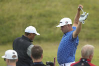 Tiger Woods of the United States, left, speaks with Gary Woodland of the United States at the practice ground ahead of the start of the British Open golf championships at Royal Portrush in Northern Ireland, Tuesday, July 16, 2019. The British Open starts Thursday. (AP Photo/Jon Super)