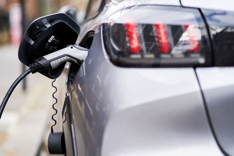 A Peugeot electric car plugged into a EV charging point