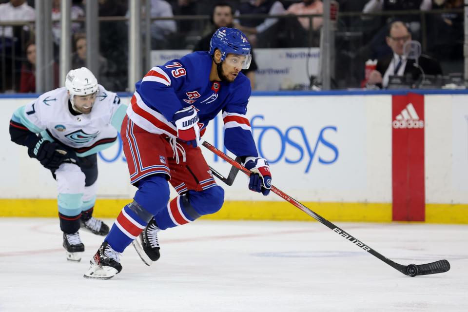 Jan 16, 2024; New York, New York, USA; New York Rangers defenseman K'Andre Miller (79) brings the puck up ice against Seattle Kraken right wing Jordan Eberle (7) during the third period at Madison Square Garden.