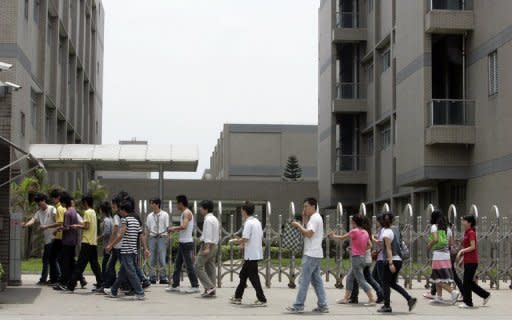 This file photo shows workers making their way back to a Foxconn factory after their lunch break in an industrial district of Foshan City, southern China's Guangdong province. Apple chief executive Tim Cook on Tuesday said that ensuring safe working conditions at plants making its coveted gadgets is a priority, as an audit of a key supplier continued in China