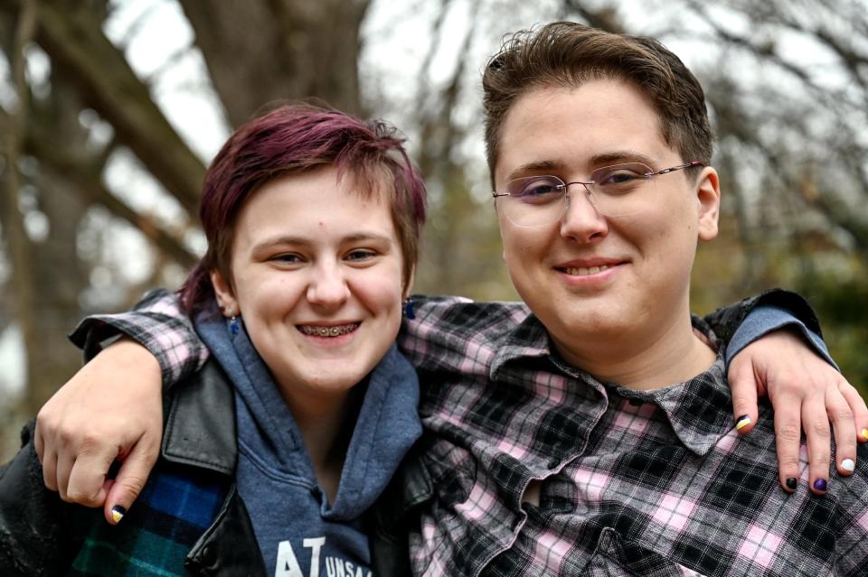 Transgender siblings Newt, 14, left, and Ellie Wheeler, 19, on Dec. 9, 2022, outside their home in East Lansing, Mich.